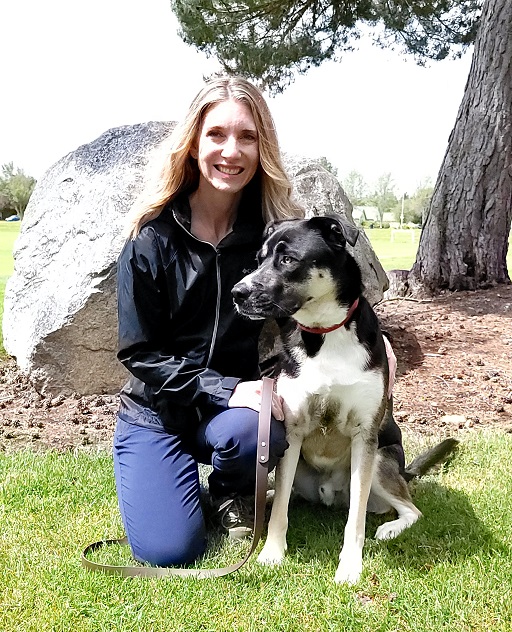 A picture of Stephanie Beall with a dog.